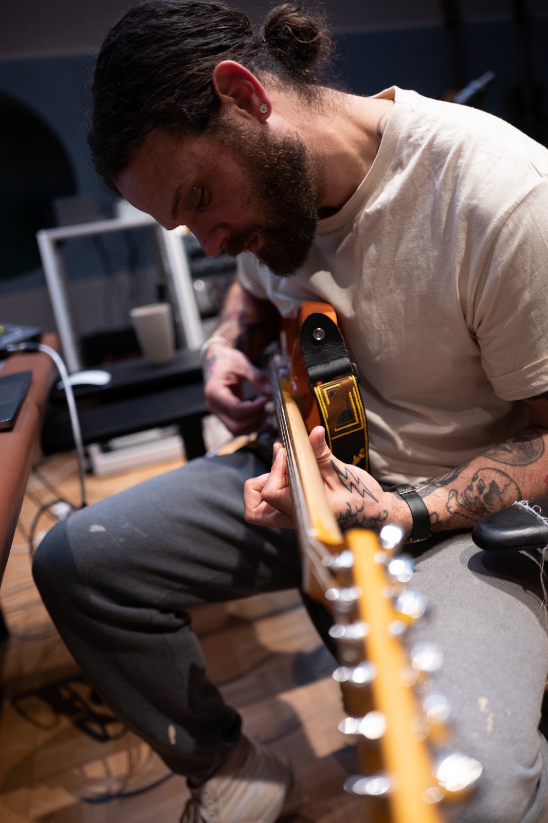 max mostley playing guitar in the studio